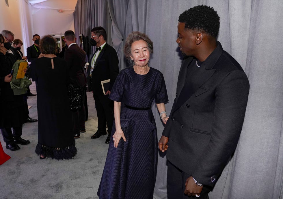 los angeles, california   april 25 l r yuh jung youn, winner of best actress in a supporting role for minari, and daniel kaluuya, winner of best actor in a supporting role for judas and the black messiah, pose outside the press room at the oscars on sunday, april 25, 2021, at union station in los angeles photo by chris pizzello poolgetty images