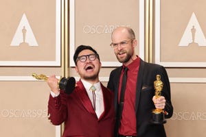 daniel kwan and daniel scheinert hold their oscar trophys