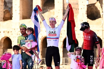 tadej pogacar with a united arab emirates and slovenian flag at the 2024 giro ditalia