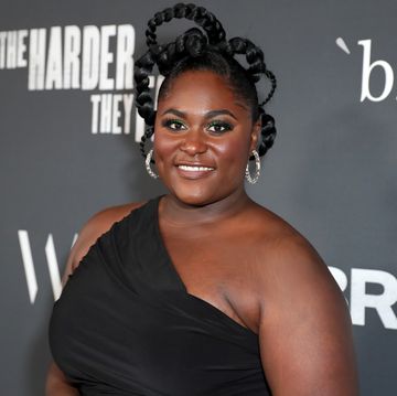 danielle brooks smiles as she attends a red carpet event