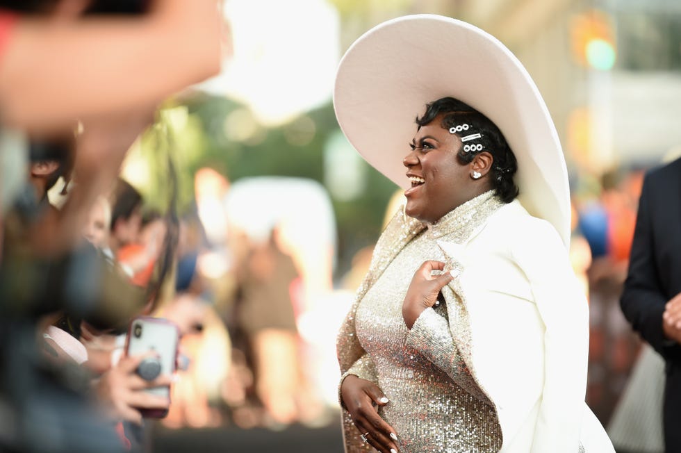 finger waves are a short black hairstyle idea as seen on  danielle brooks who pairs them with an oversized hat