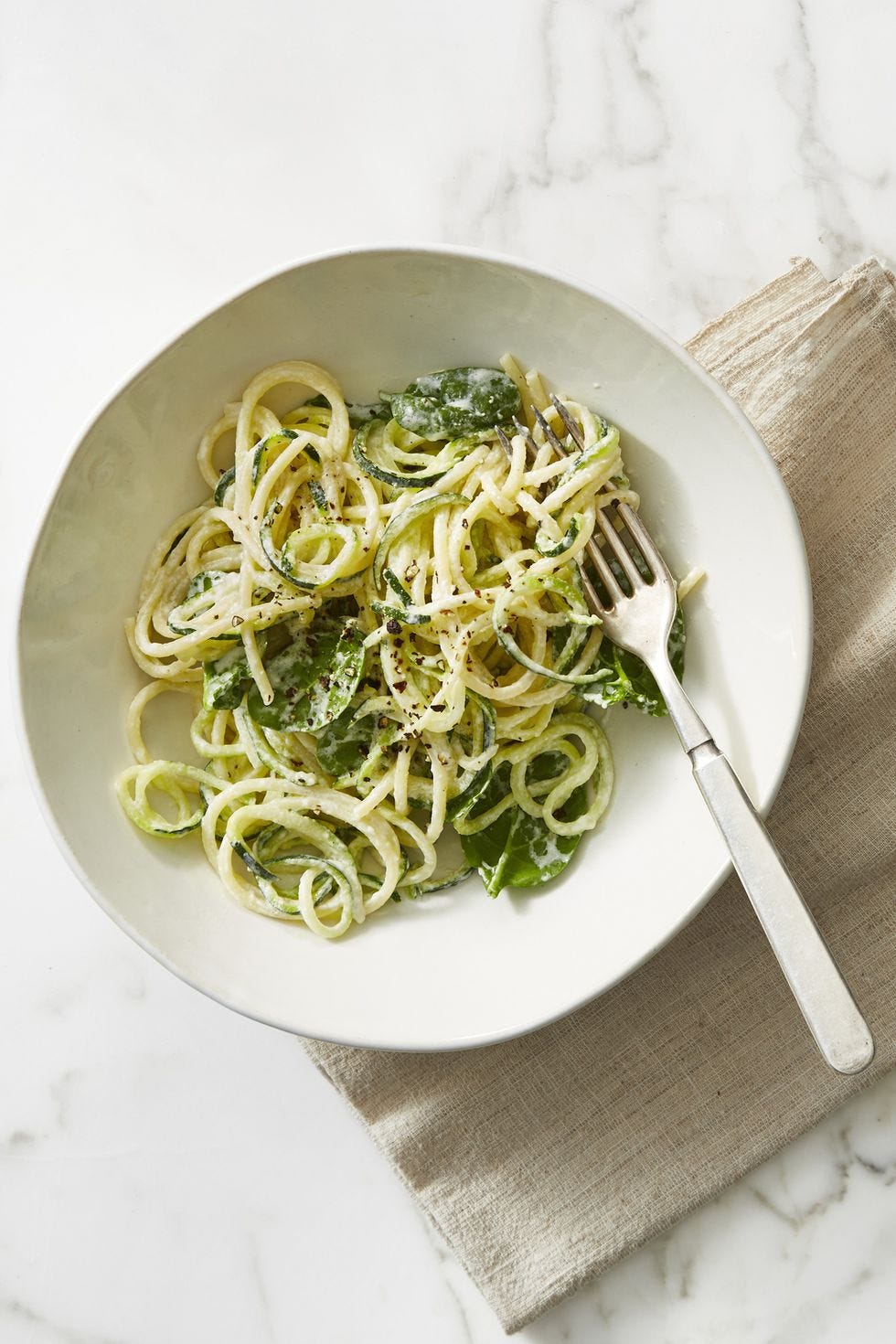 spaghetti zucchini in a bowl with a fork
