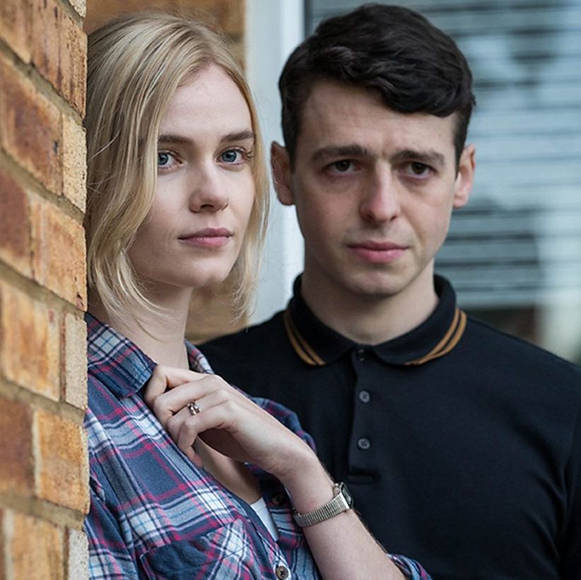 leah mcnamara and anthony boyle in danny boyle standing next to a brick wall