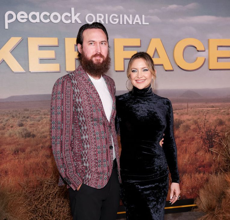 kate hudson and her fiance danny fujikawa embracing and smiling for a photo