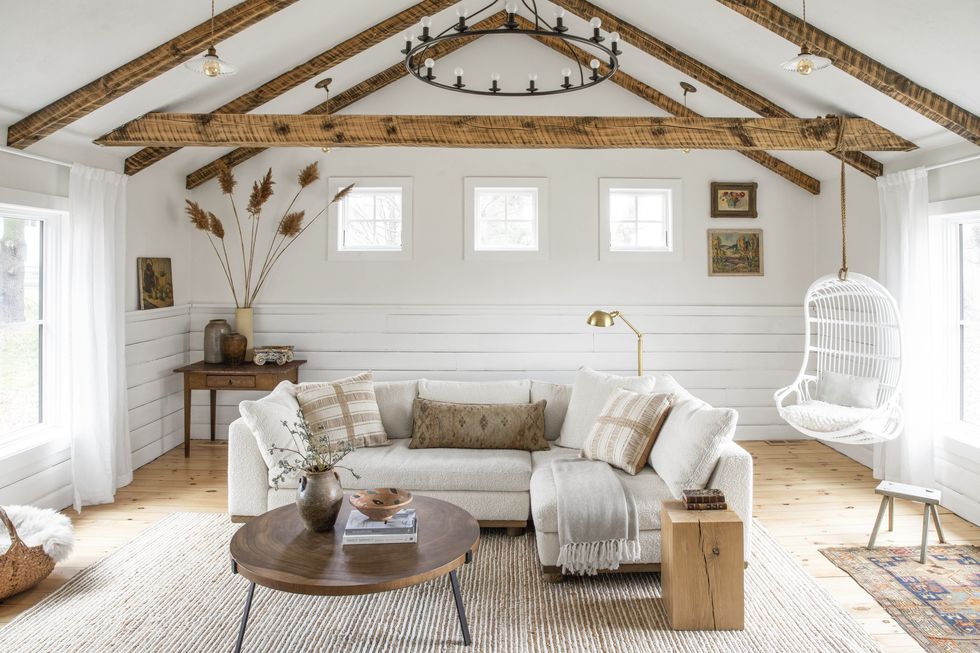 neutral cabin living room with wood beams