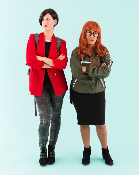 two women dressed as jane and daria from daria standing against a blue background the costume idea is a good housekeeping pick for best 90s halloween costumes