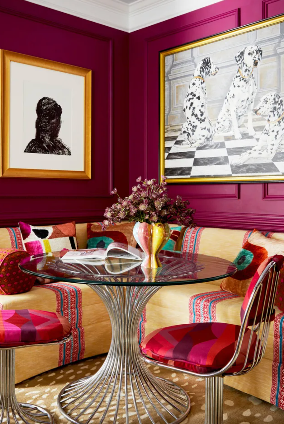 dining area with dark pink walls