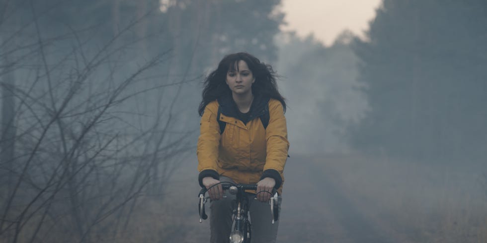 cyclist navigating through a foggy wooded path