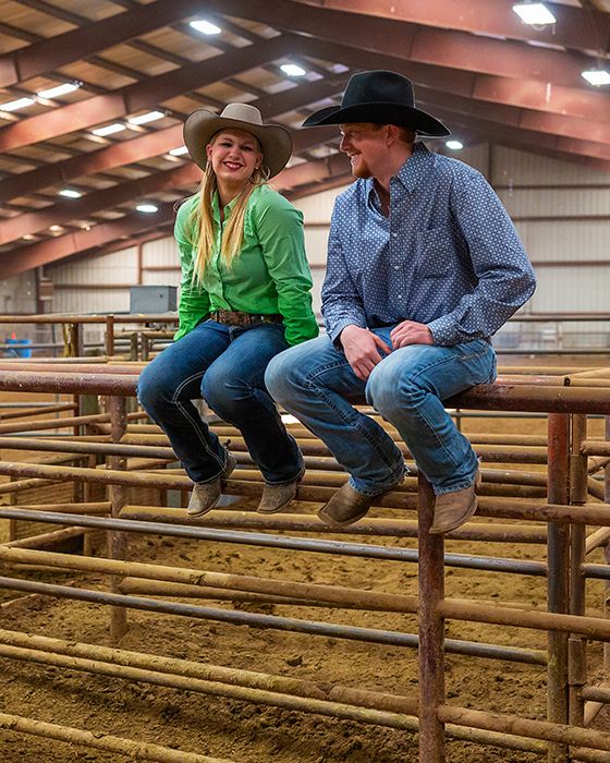 date night ideas with a man and a woman sitting in a rodeo barn