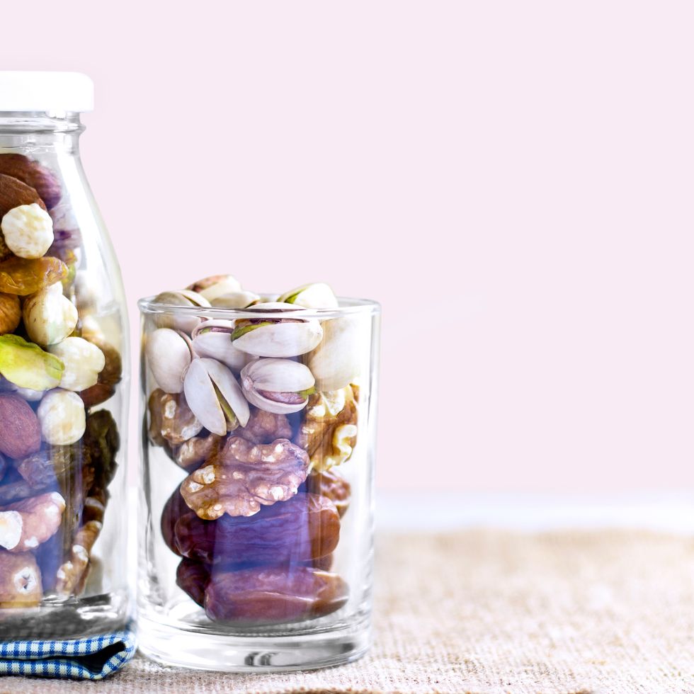 dates, pistachios, and walnuts in glass