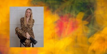 a fashionable individual in a leopard print outfit seated on a chair