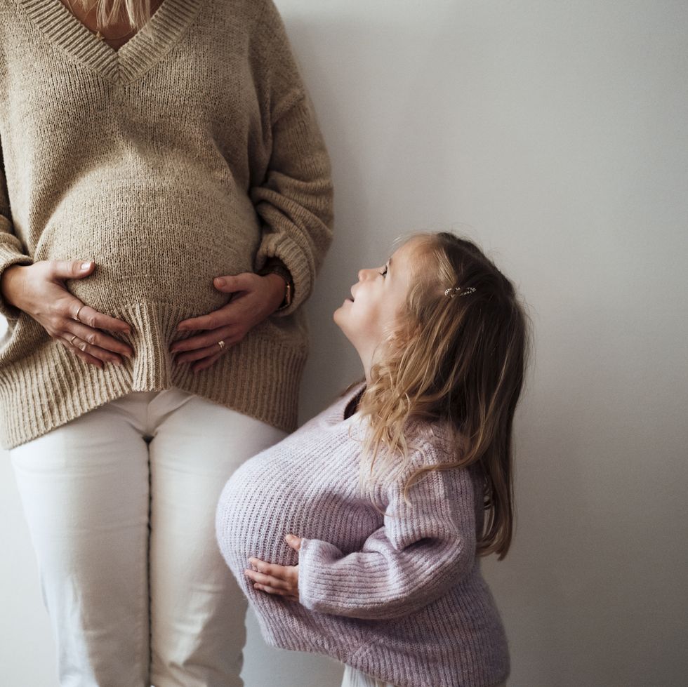 Daughter who imitates Mothers' pregnancy for the wall