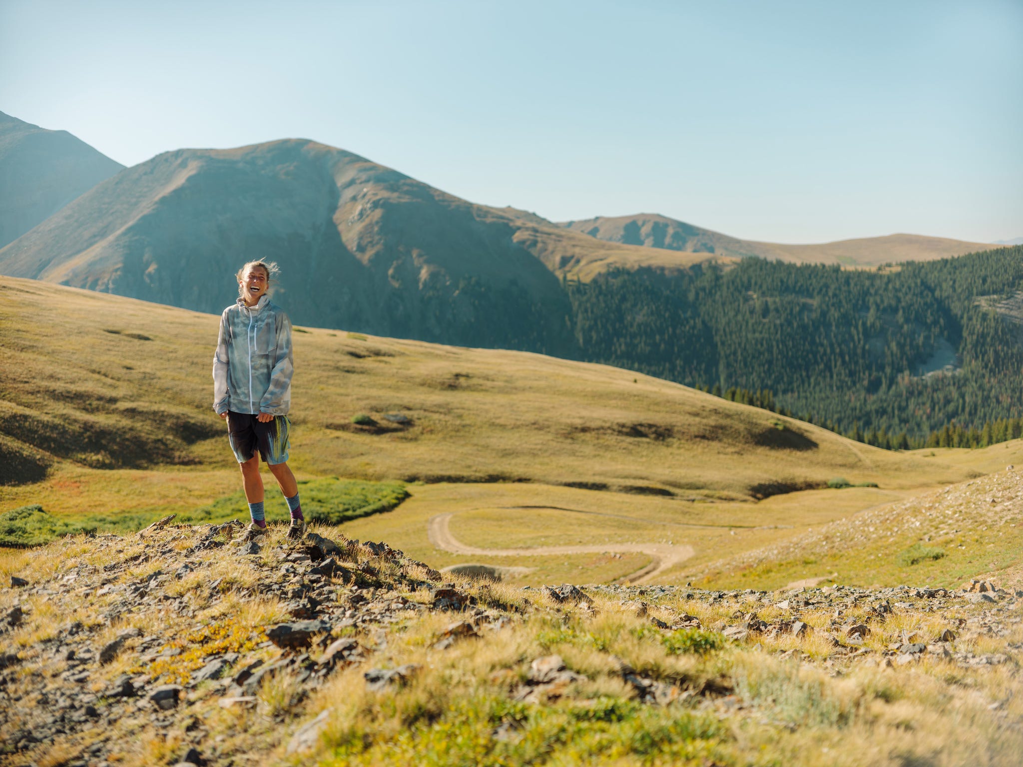 a runner on a mountainous trail