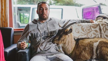 David Paul Cook with a goat friend he met while running 10 Marathons in 10 Days in 2019.