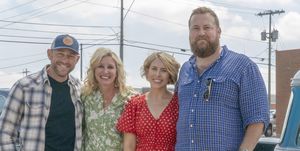 as seen on home town takeover, ben and erin napier pose for a photo with partners dave and jenny mars in downtown fort morgan, colorado