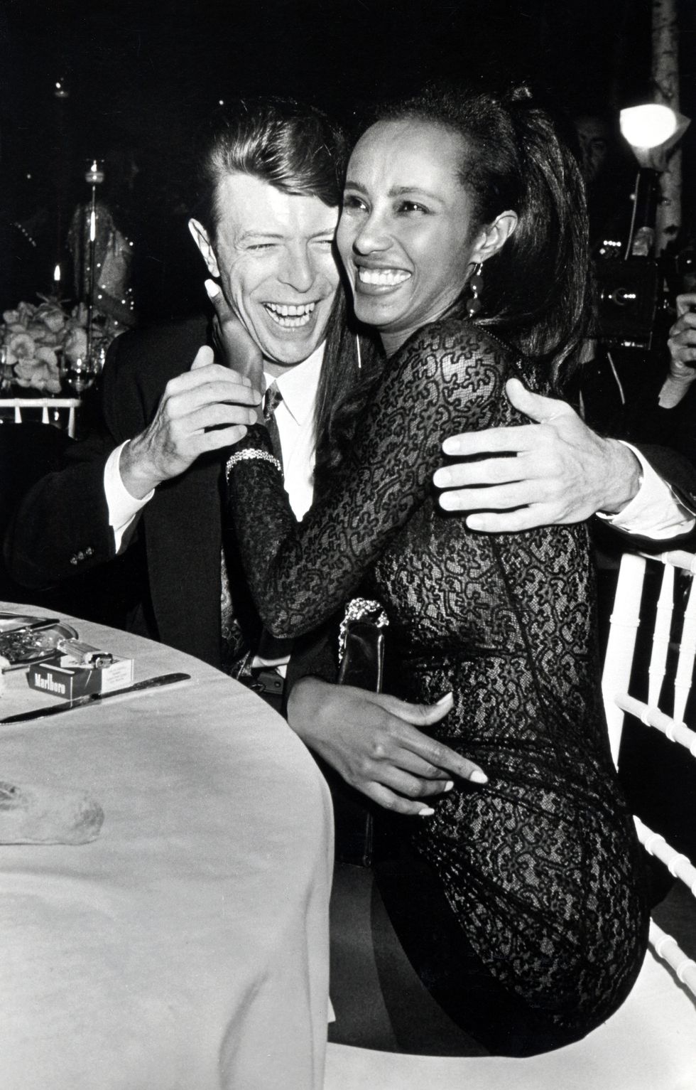David Bowie and Iman laughing and embracing