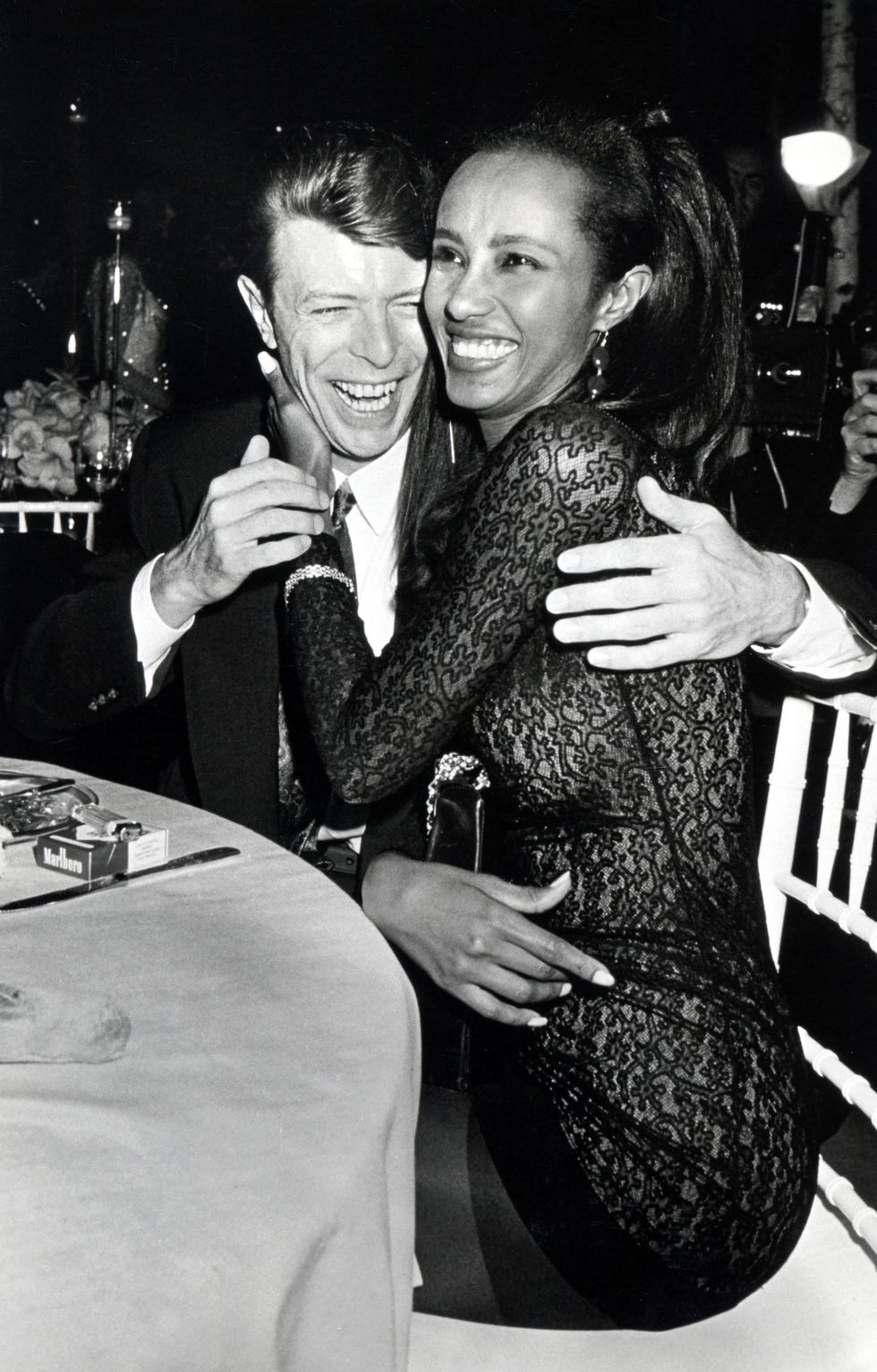 David Bowie and Iman laughing and embracing