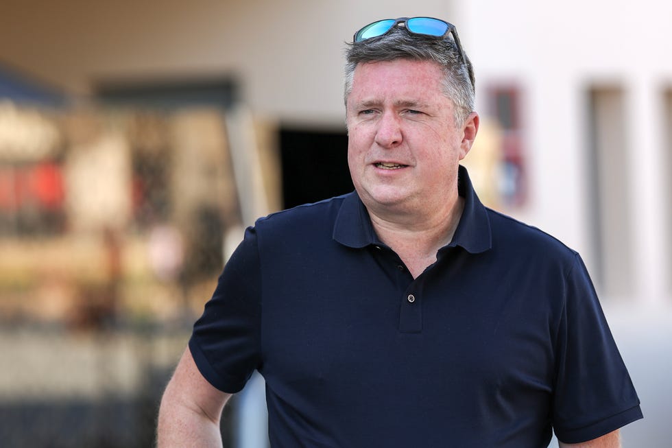 formula 1 commentator david croft walks through the paddock