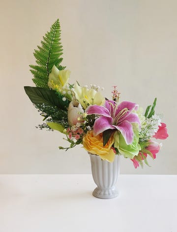 arrangement of artificial flowers in a decorative vase