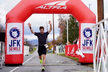 runner crossing finish line at a race event