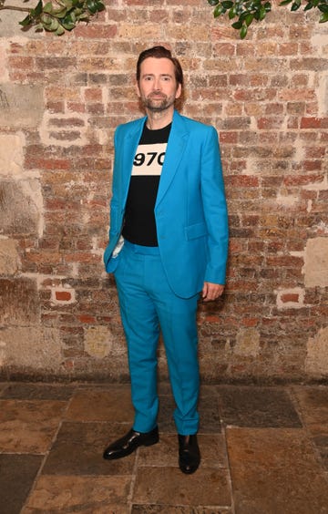 david tennant in a bright blue suit with a black and white shirt