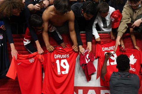 vancouver, bc   june 09 alphonso davies of canada signs autographs for the fans on replica shirts after the canada v curacao concacaf nations league group c match at bc place on june 9, 2022 in vancouver, canada photo by matthew ashton   amagetty images