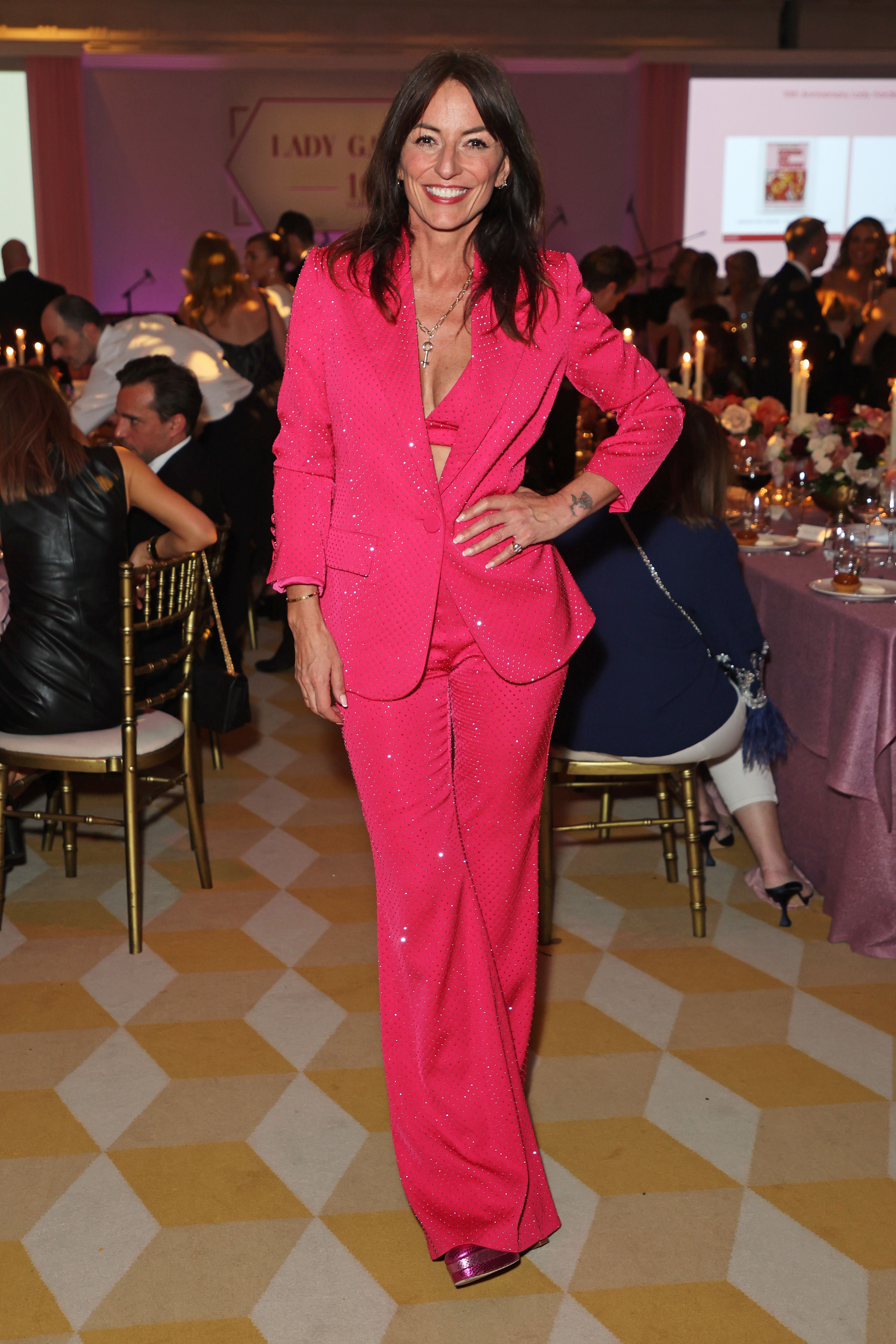 Davina McCall wears a pink bra and trouser suit to celebrate IWD