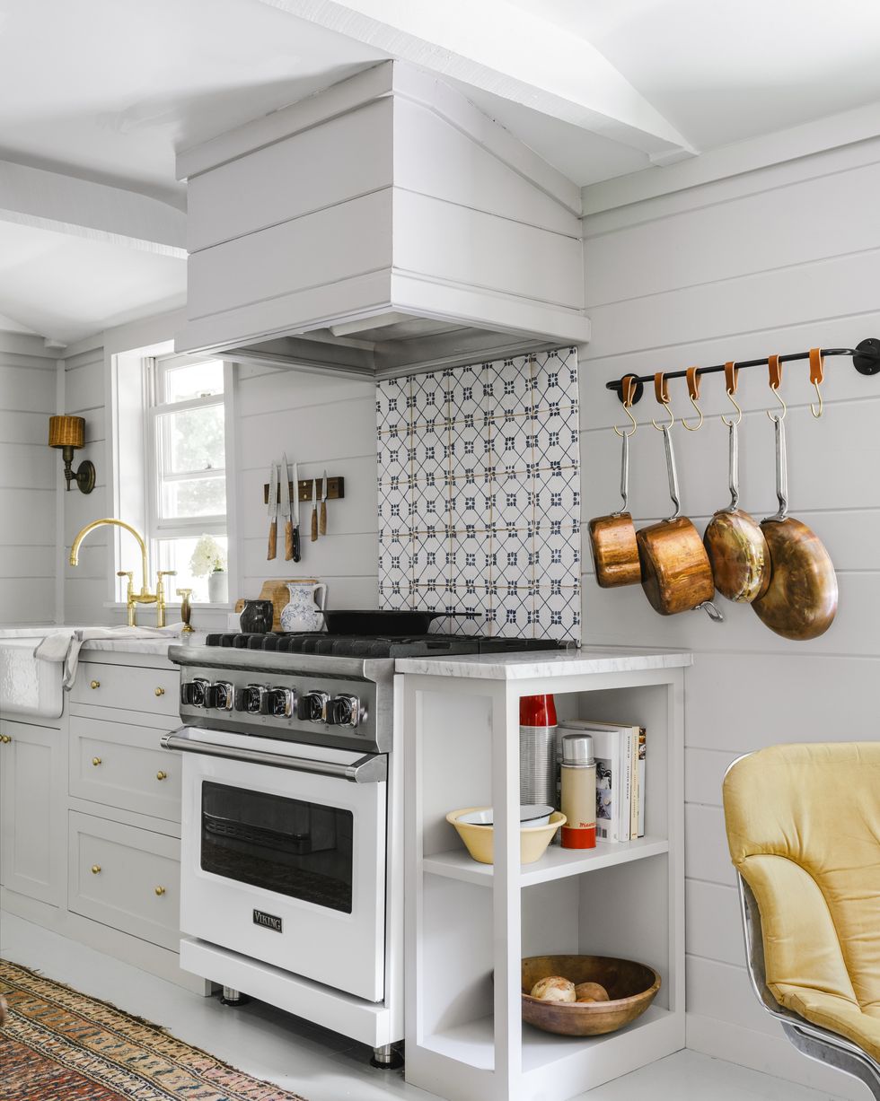 small all white shiplap galley kitchen with graphic tile backsplash