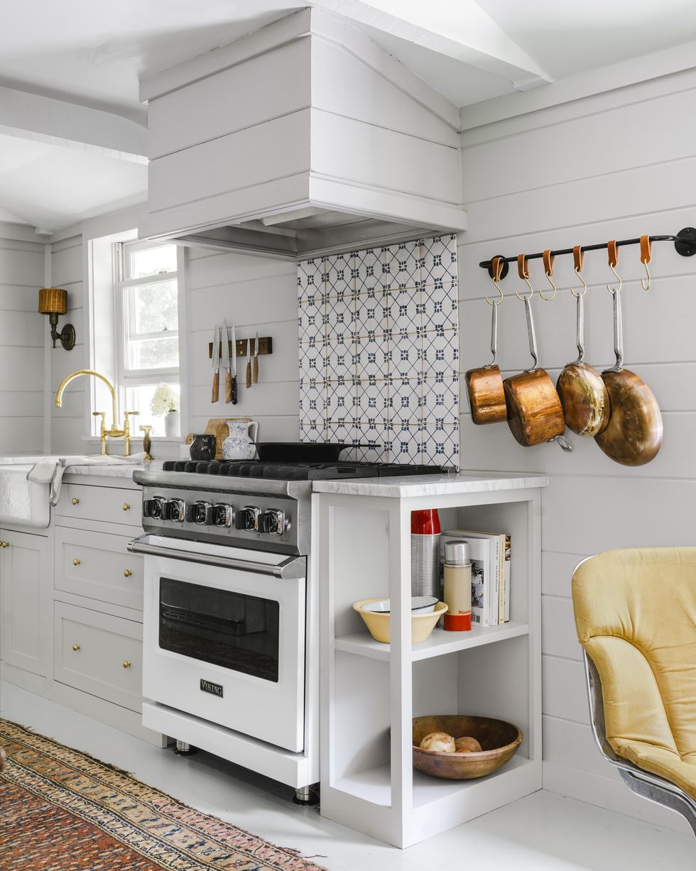 small all white shiplap galley kitchen with graphic tile backsplash
