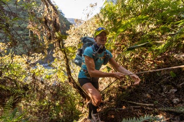 smiling woman trekking through a jungle