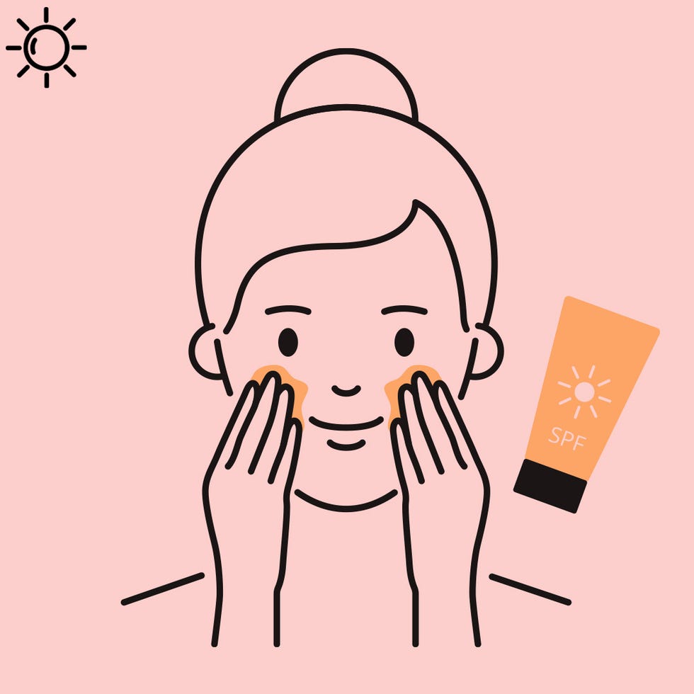 woman applying sunscreen to face
