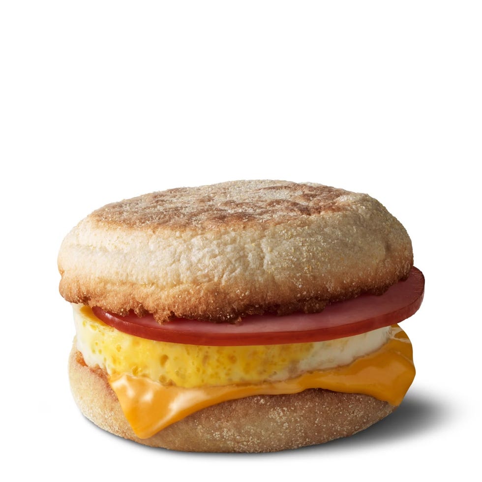 breakfast sandwich with layers of egg cheese and ham on an english muffin