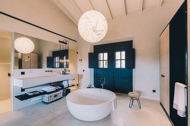 A hotel suite with a deep bathtub.