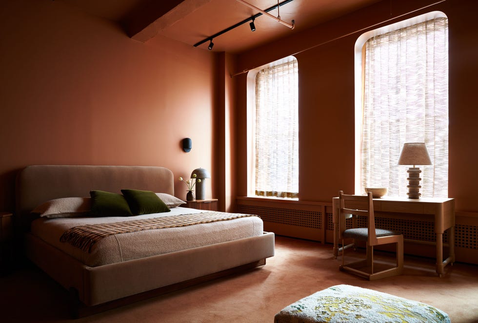 Cozy modern bedroom with warm tones and minimalistic furniture.