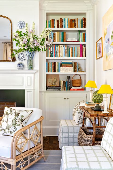 living room, white and green skirted chairs, white built in bookcase, fireplace