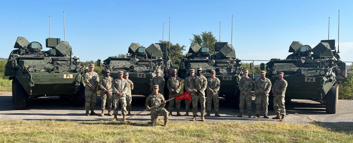 soldiers of 60th air defense artillery regiment stand before four de m shorad vehicles based on stryker but armed with a 50 kilowatt laser