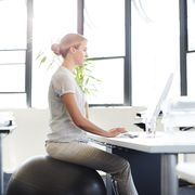 woman sitting on stability ball at desk