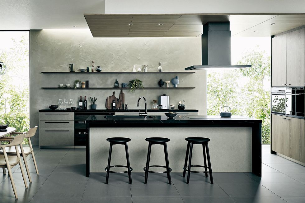 a kitchen with stools and a counter top