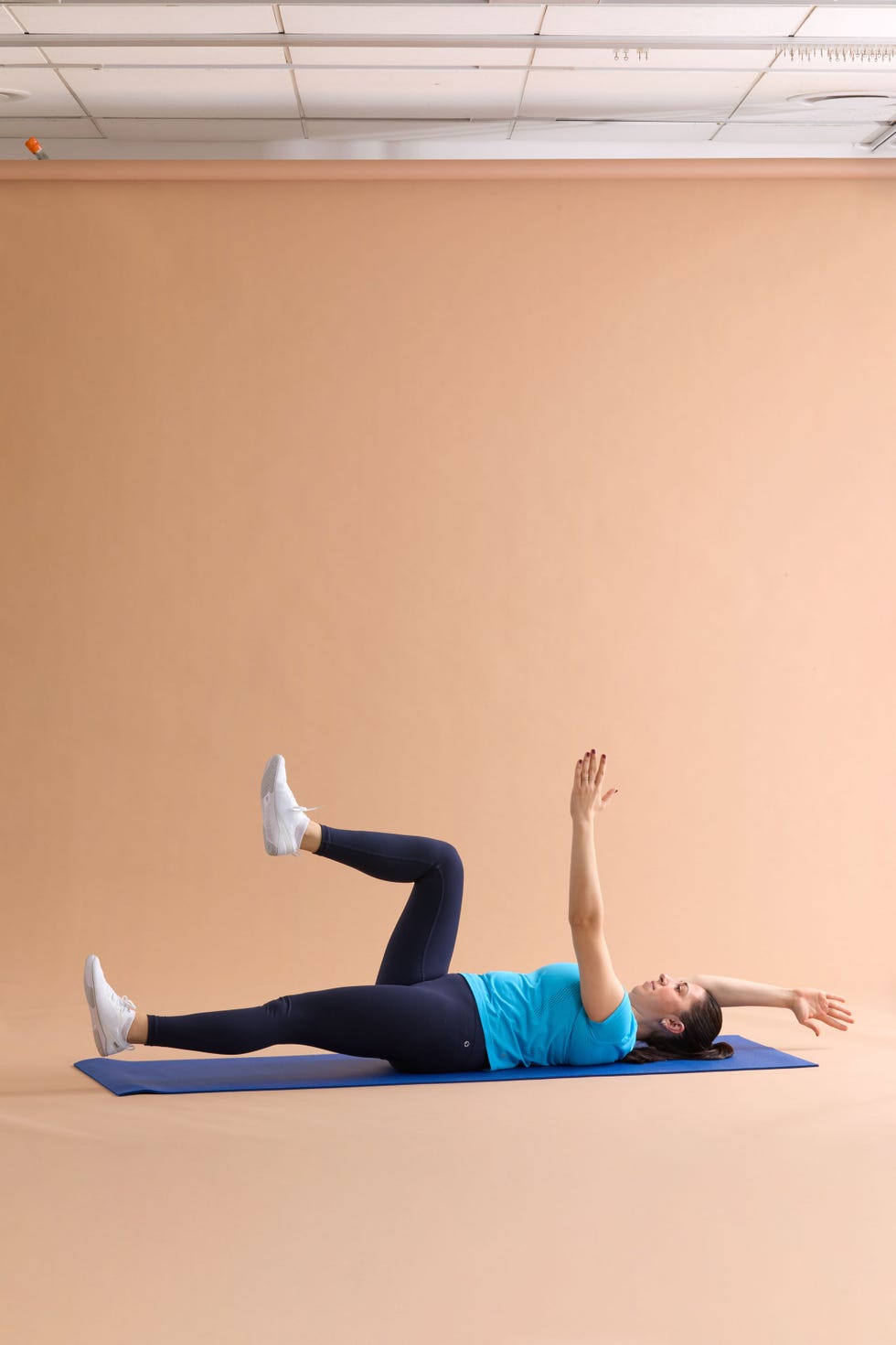 A person performing an exercise on a yoga mat