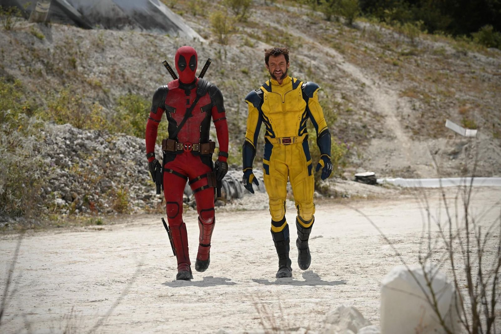 two men walking in superhero suits