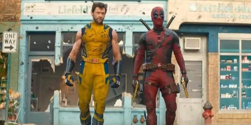 wolverine and deadpool stand in front of a store called leifield's just feet