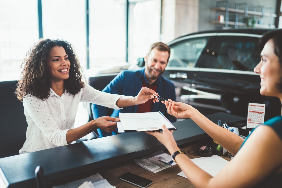 couple in the showroom buying new car