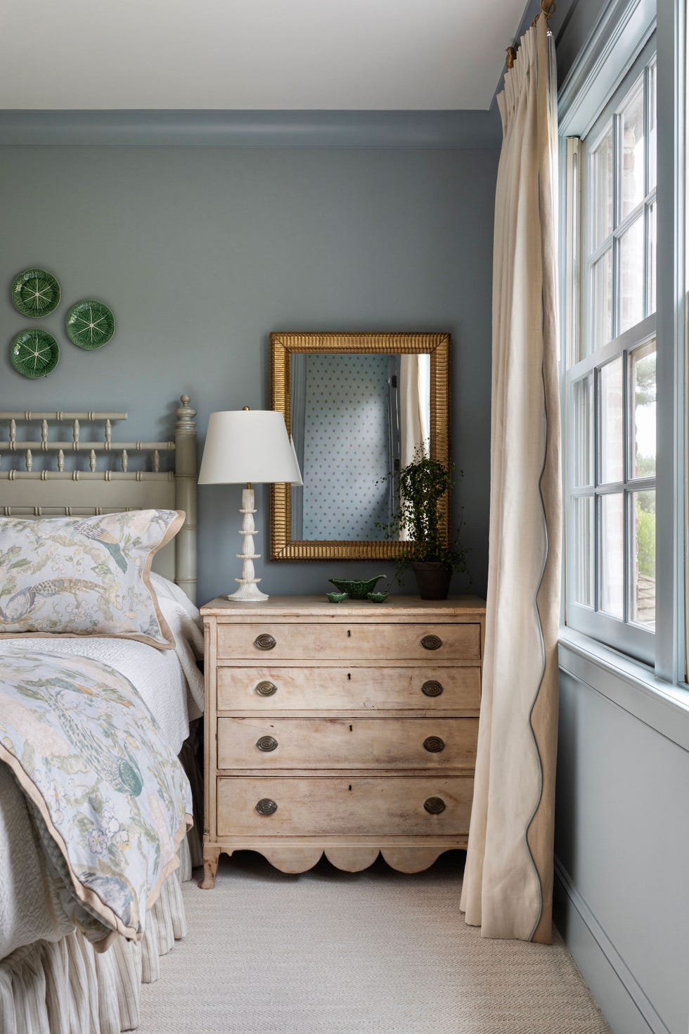 blue bedroom with antique wood nightstand