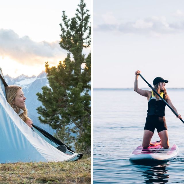 a man and a woman on a paddle board with a tent and a tree