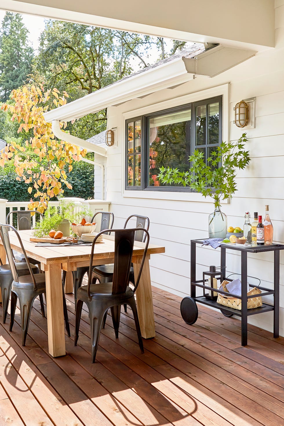 deck with dining area and bar cart