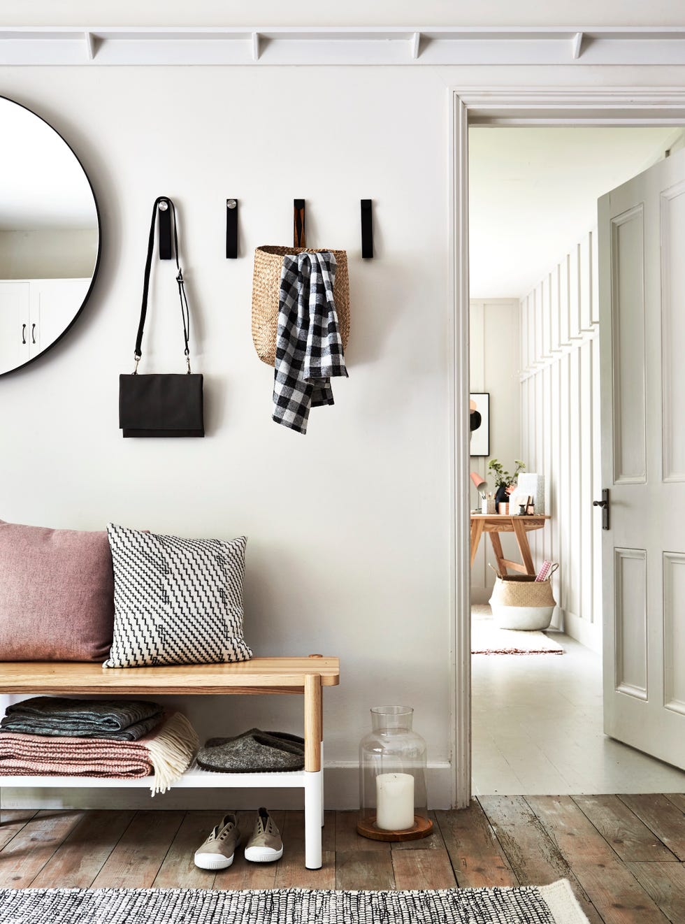 organised hallway with bench for cushions and throws, and a coat peg