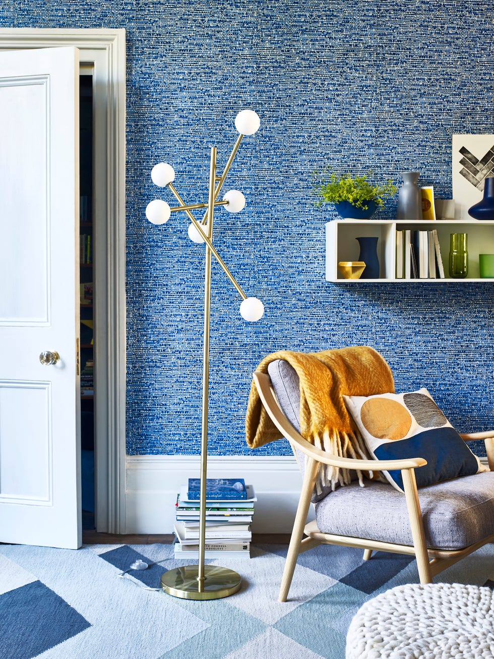 living room with blue textured wallpaper and a floor lamp