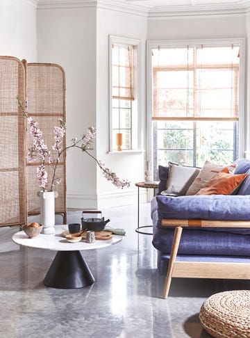 a living room with a blue couch and a table