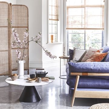 a living room with a blue couch and a table