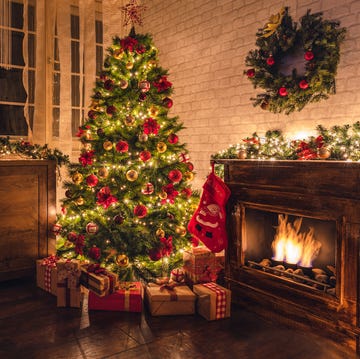Decorated Christmas Tree Near Fireplace at Home decorated christmas tree near fireplace at home